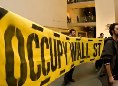 Banner held by Occupy Museum protester