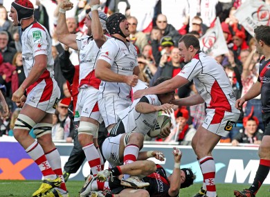 The Ulster players celebrate Pedrie Wannenburg's try.