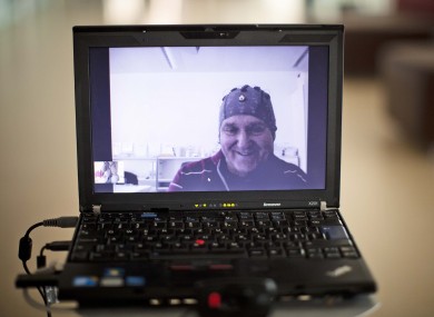 Mark-Andre Duc, a partially tetraplegic patient, is seen on a laptop screen as he talks to scientists in Switzerland's Federal Institute of Technology in Lausanne, Switzerland, Tuesday, April 24, 2012