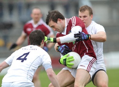 Nicky Joyce, centre, is tackled by Ollie Lyons and Peter Kelly of Kildare.