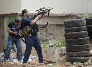 A Sunni gunman fires during a clashes in the northern port city of Tripoli, Lebanon today.