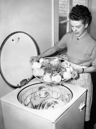 Miss Joyce Toll demonstrating the 'Dishmaster' machine in 1952. Bless.