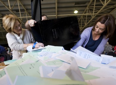 Polling staff open the ballot boxes for the count at last year's presidential election.