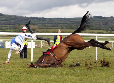 Ruby Walsh falls from Call the Police on the last fence whilst leading the Aon Handicap Steeplechase.