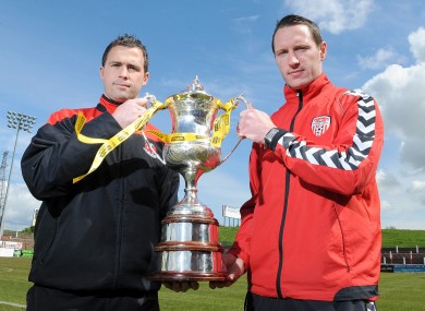 Derry City's Barry Molloy and Crusaders' David Rainey with the Setanta Cup yesterday.