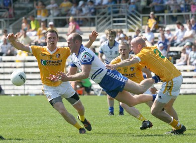 Dick Clerkin of Monaghan under pressure from Michael McCann, Paddy Cunningham and Anto Healey of Antrim.