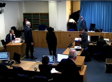 The protester (centre) is bundled from the room. Tony Blair can be seen seated at the left hand side of the room