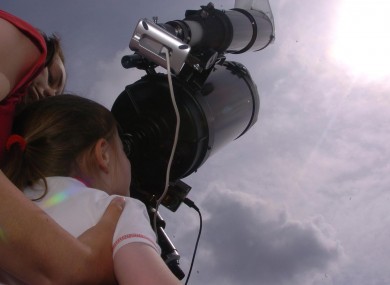 June 2004: Christine Keogh, 13, from Dublin, helps her sister Kate look through a telescope to see the planet Venus passing across the Sun's face.
