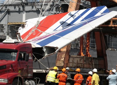 Workers unloading debris, belonging to crashed Air France flight AF447, from the Brazilian Navy's Constitution Frigate