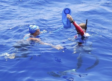 Diana Nyad is hydrated by a crew member in the Florida Straits yesterday.