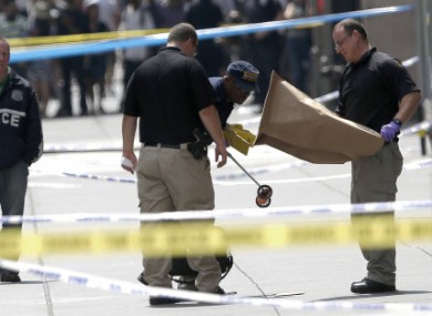 Police collecting evidence at the scene of yesterday's shooting.