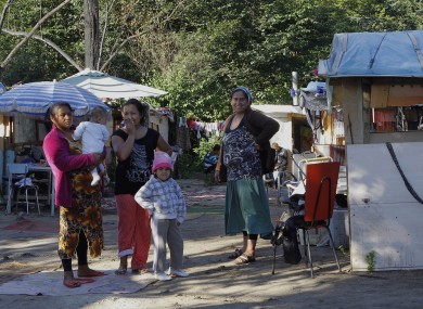 Roma gypsies rest in a camp in Evry, outside Paris, Monday Aug. 27, 2012