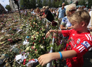 1 August 2011: Floral tributes to the victims of the two attacks are left outside Oslo Cathedral.
