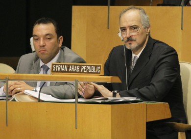 Syria's UN Ambassador Bashar Ja'afari, right, listens to speakers during a meeting of the United Nations General Assembly at the United Nations Friday, Aug. 3, 2012