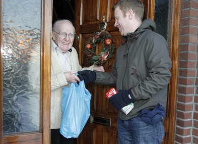 John Sherwin from the Dublin City charity, Care Local, visits 87-year-old Joe Reddin to deliver groceries.