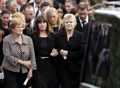 Essie Spence (right) wife of Noel and the mother of Graham and Nevin Spence, with Graham's wife Andrea (centre) walking behind the three coffins.