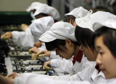 A file photo of workers on an assembly line at a Foxconn plant in Shenzhen, China.