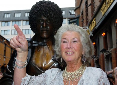 Philomena in front of the statue of her son on the corner of Grafton Street in Dublin in 2005.