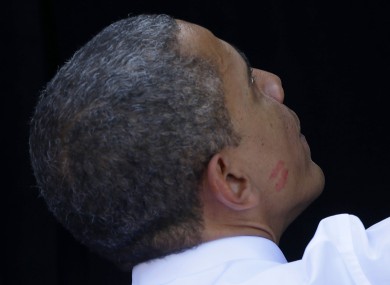 A lipstick kiss is visible on the right cheek of President Barack Obama