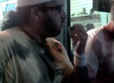 This frame grab made from video on Friday, Oct. 5, 2012, and provided by John-Patrick McNown shows Edward Archbold competing in a roach-eating contest at Ben Siegel Reptile Store in Florida.