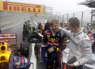 Michael Schumacher (right) congratulates Sebastian Vettel on his achievement.
