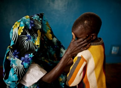 A victim of mass rape and her son in the town of Fizi, Democratic Republic of Congo (DRC) on Sunday, Feb. 20, 2011.