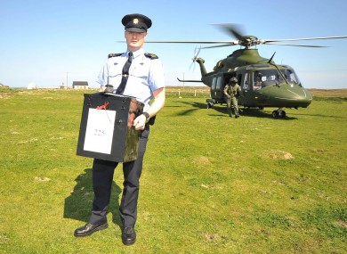 Garda Eugene Organ carrying a ballot box to the polling station on Tory island for the fiscal compact referendum earlier this year.
