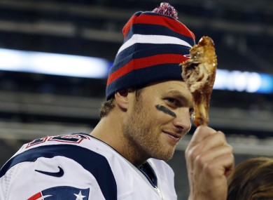 New England Patriots quarterback Tom Brady holds a turkey leg after the NFL game against the New York Jets.
