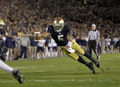 Notre Dame quarterback Everett Golson dives into the end zone in front of Pittsburgh linebacker Joe Trebitz for a two-point conversion to tie the game late in the fourth quarter.