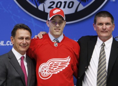 Riley Sheahan, centre, flanked by Detroit Red Wings general manager Ken Holland, left, and Joe McDonnell, director of amateur scouting, at the 2010 NHL hockey draft (file photo).