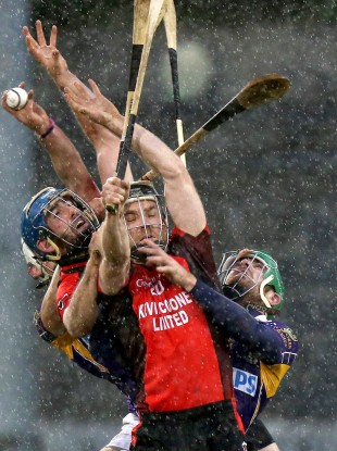 Kilmacud Crokes and Oulart-The-Ballagh players battle for possession.