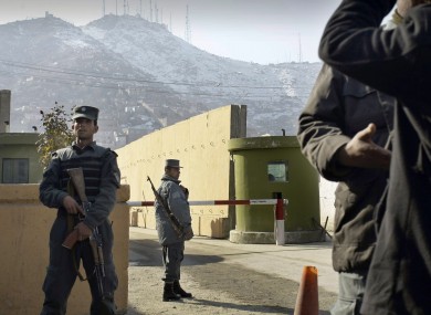File photo: Afghan police officers stand guard outside of Kabul police headquarters, where a an American contractor was killed, in Kabul, Afghanistan.