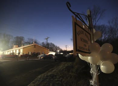 White balloons decorate a sign for the Sandy Hook Elementary School, early this morning.