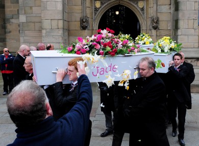 A mourner throws flower petals as coffins leave the funeral service of the Philpott children held at St Mary's RC Church on Bridgegate, Derby on 22 June.