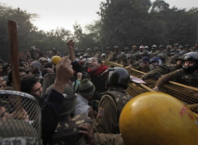 An Indian protester shouts slogans as he is stopped by police during a protest against a recent gang-rape of a young woman in a moving bus in New Delhi, India