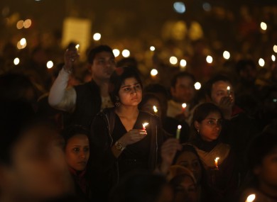 People hold candles at a vigil on Saturday to mourn the death of the 23-year-old medical student
