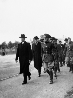 Éamon de Valera, left, and Frank Aiken, Minister for Defence being escorted by officers of the Free State Army, on the former's arrival on Spike Island, on 11 July, 1938.
