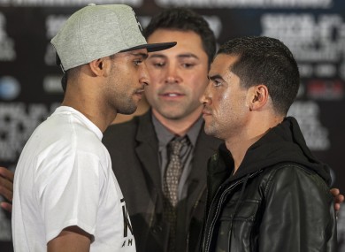 Golden Boy Promotions president Oscar De La Hoya, centre, presents Amir ÂKing Khan, left, and his opponent, Carlos Molina.