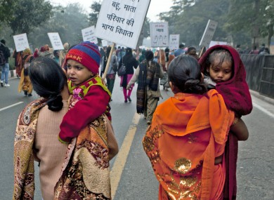 Indian women carry their children as they march during a protest to mourn the death of a gang rape victim in New Delhi.
