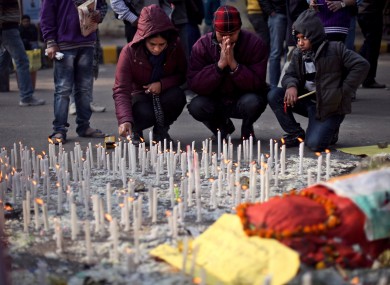 An Indian family lights candles in memory of a gang-rape victim in New Delhi, India, Saturday