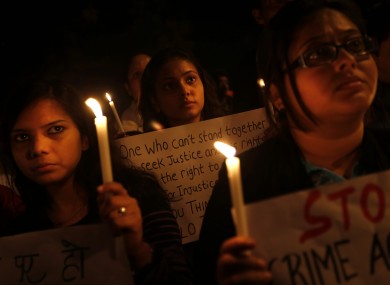 Indian students participate in a candlelight vigil to mark the passing of a month since a gang rape of a 23-year-old student in a bus, in New Delhi