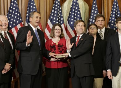 Speaker John Boehner, left, holds a mock 'swearing-in' ceremony for Tennessee congressman Chuck Fleischmann on the first day of the new Congress.