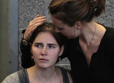 Amanda Knox is hugged by her sister Deanna shortly after arriving in Seattle after her conviction was thrown out