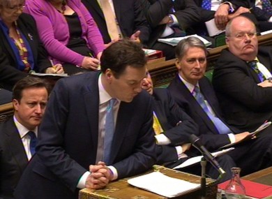 Prime minister David Cameron (left) looks on as George Osborne delivers his Budget speech in the House of Commons today.