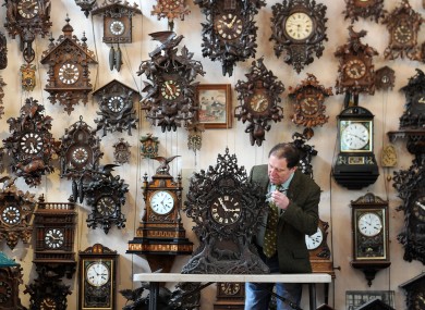 Roman Piekarski makes a start to changing the time on one of more than 600 cuckoo clocks at his Cuckooland Museum in Tabley, Cheshire before the clocks go forward on Sunday morning.