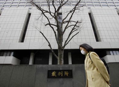 A woman walks by Tokyo District Court during a trial of 19-year-old Richard Hinds of Memphis.