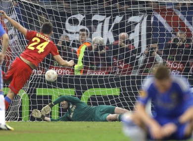 Fernando Torres can't watch as Raul Rusescu smashes home a penalty.