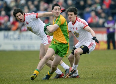 Tyrone's Sean Cavannagh with Matthew Donnelly and Donegal's Mark McHugh.