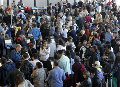 Passengers gather at the American Airlines check-in for flights at Los Angeles International Airport.