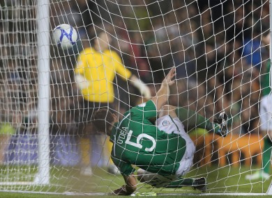 Darren O'Dea gets tangled in the net after Germany score against Ireland.